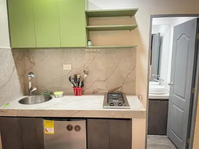 a small kitchen with a sink and a stove at Loft Urbano la 70 Laurles estadio in Medellín
