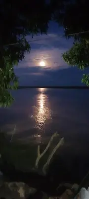 a view of a full moon over the water at Hospedaje Luz d' Luna in Puerto Triunfo