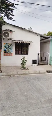 a white building with a sign on the side of it at Hospedaje Luz d' Luna in Puerto Triunfo