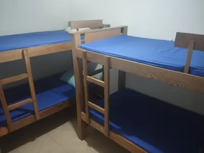 two bunk beds in a room with blue sheets at SANTAFE APARTASOLES in Santa Fe de Antioquia