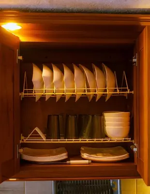 a cabinet filled with plates and bowls and dishes at Suite Doble in Jericó
