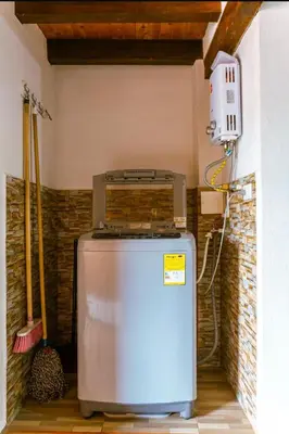 a small refrigerator in a corner of a room at Suite Doble in Jericó