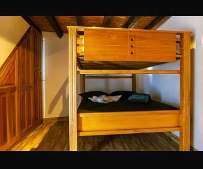 a wooden bunk bed in a room at Suite Doble in Jericó