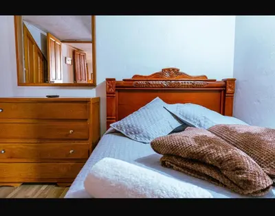 a bedroom with a bed with a dresser and a mirror at Suite Doble in Jericó