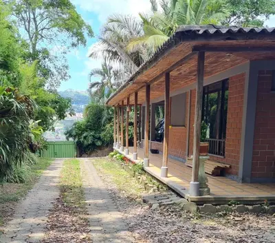 a brick house with a porch on a street at Casa Vélez in Villamaría
