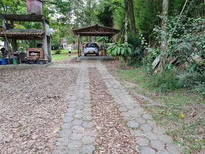 a cobblestone road with a pavilion and a car on it at Casa Vélez in Villamaría