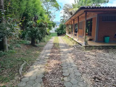 a stone path next to a house and a building at Casa Vélez in Villamaría