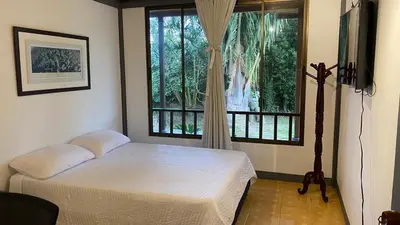 a bedroom with a bed and a large window at Casa Vélez in Villamaría