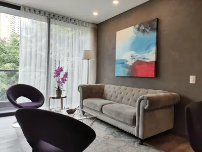 a living room with a couch and two chairs at Tropical Confort suite Poblado in Medellín