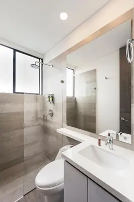 a bathroom with a white toilet and a sink at Tropical Confort suite Poblado in Medellín