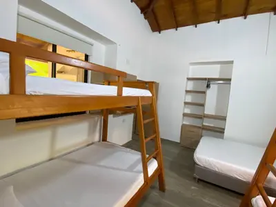 a room with two bunk beds and a bed at CRISTALES DEL RIO RESORT in San Rafael