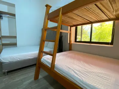 a bunk bed room with two bunk beds and a ladder at CRISTALES DEL RIO RESORT in San Rafael
