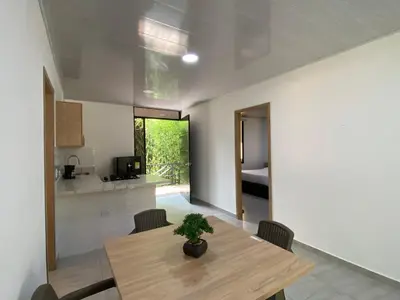 a dining room and kitchen with a table and chairs at CRISTALES DEL RIO RESORT in San Rafael