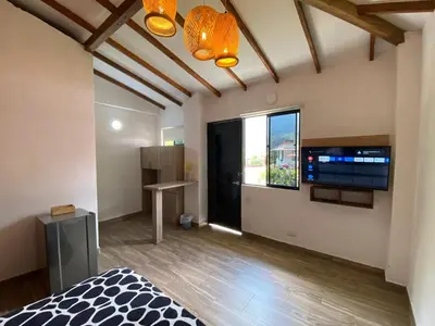 a bedroom with a bed and a large window at CRISTALES DEL RIO RESORT in San Rafael