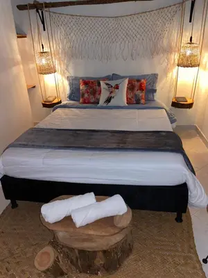 a bedroom with a large bed with two towels on it at Casa Magia in Urrao