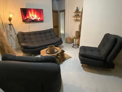 a living room with two couches and a fireplace at Casa Magia in Urrao