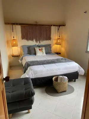 a bedroom with a large bed and a couch at Casa Magia in Urrao