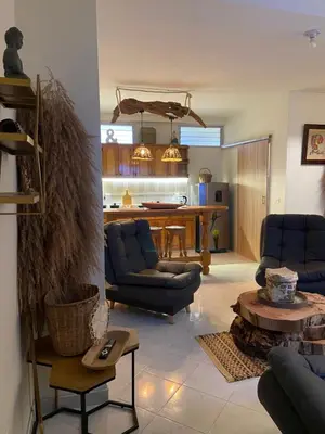 a living room with blue chairs and a table at Casa Magia in Urrao