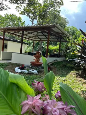a gazebo with a fountain in a garden at Finca Maribet in Cisneros