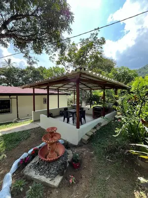 a gazebo with a table and a fountain at Finca Maribet in Cisneros