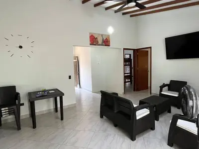 a living room with black furniture and a flat screen tv at Finca Maribet in Cisneros