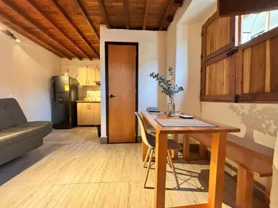 a living room with a table and a kitchen at ApartaLoft Carolina in Carolina del Principe