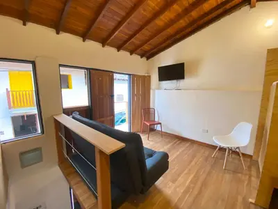 a living room with a couch and a tv at ApartaLoft Carolina in Carolina del Principe