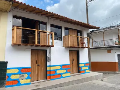 a colorful house with wooden doors and balconies at ApartaLoft Carolina in Carolina del Principe