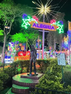 a statue in front of an amusement park at night at ApartaLoft Carolina in Carolina del Principe
