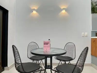 a table with chairs and a sign on it at Apartments with Jacuzzi in El Poblado by Wynwood House in Medellín