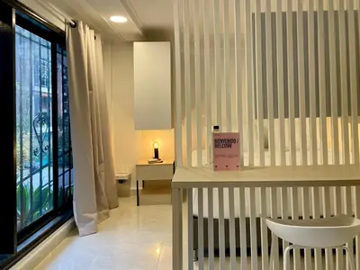 a room with a table and a chair and a window at Apartments with Jacuzzi in El Poblado by Wynwood House in Medellín