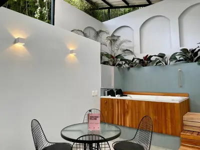 a table and chairs in a room with plants at Apartments with Jacuzzi in El Poblado by Wynwood House in Medellín