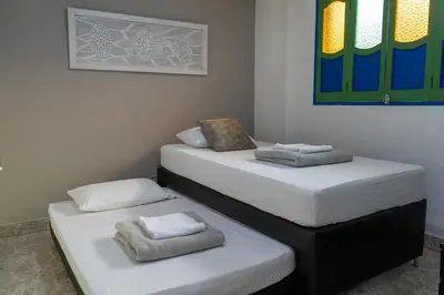 two beds sitting next to each other in a room at Apartamento Parque de Guatapé in Guatapé