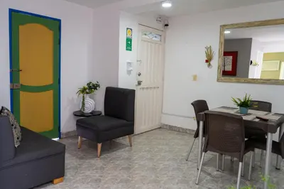 a room with a table and a chair and a mirror at Apartamento Parque de Guatapé in Guatapé
