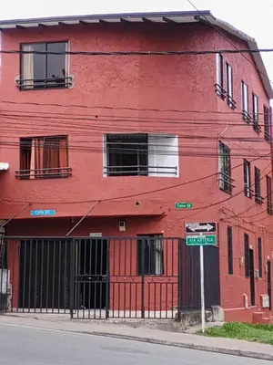 a red building on the corner of a street at Hermoso Apartamento en Medellín in Medellín