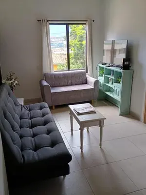 a living room with a couch and a coffee table at Hermoso Apartamento en Medellín in Medellín