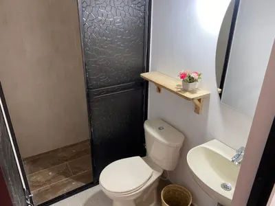 a bathroom with a toilet and a shower and a sink at Hermoso Apartamento en Medellín in Medellín