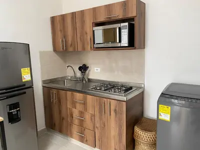 a small kitchen with a sink and a microwave at Hermoso Apartamento en Medellín in Medellín