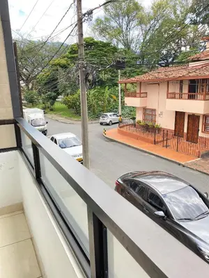 a balcony with a car parked on a street at Hermoso apartamento cerca al Poblado in Medellín
