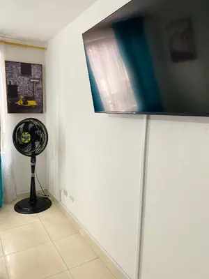 a flat screen tv sitting on top of a wall at Hermoso apartamento cerca al Poblado in Medellín