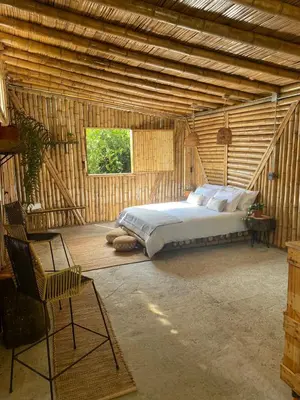 a bedroom with a bed in a wooden room at Zioru cabaña in Belalcázar