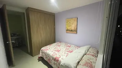 a small bedroom with a bed and a painting on the wall at Habitación Masculina 1 persona en Apartamento Compartido Medellín in Medellín