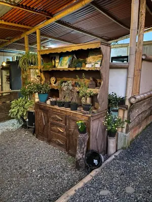 a wooden cabinet with potted plants on it at Turmequé cabaña in Alto de la Mina