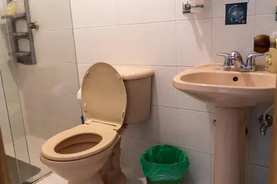 a bathroom with a toilet and a sink at Apartamento Parque Central Guatapé in Guatapé