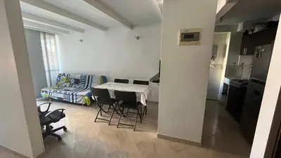 a kitchen and a living room with a table and chairs at Apartamento en Bello in Bello