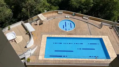an overhead view of a swimming pool with a clock at Apartamento en Bello in Bello