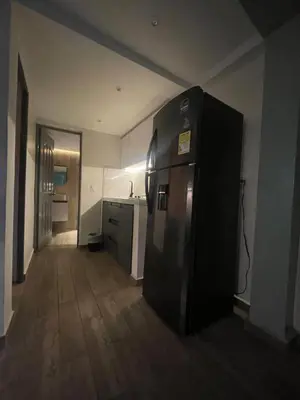 a kitchen with a refrigerator in the middle of a room at The oasis apartamento de 3 alcobas Laurles estadio LA70 in Medellín