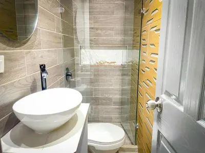 a bathroom with a white sink and a toilet at The oasis apartamento de 3 alcobas Laurles estadio LA70 in Medellín