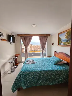 a bedroom with a bed and a large window at HOTEL MONTERREY in Ruiosucio