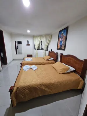 a bedroom with two beds with towels on them at HOTEL MONTERREY in Ruiosucio